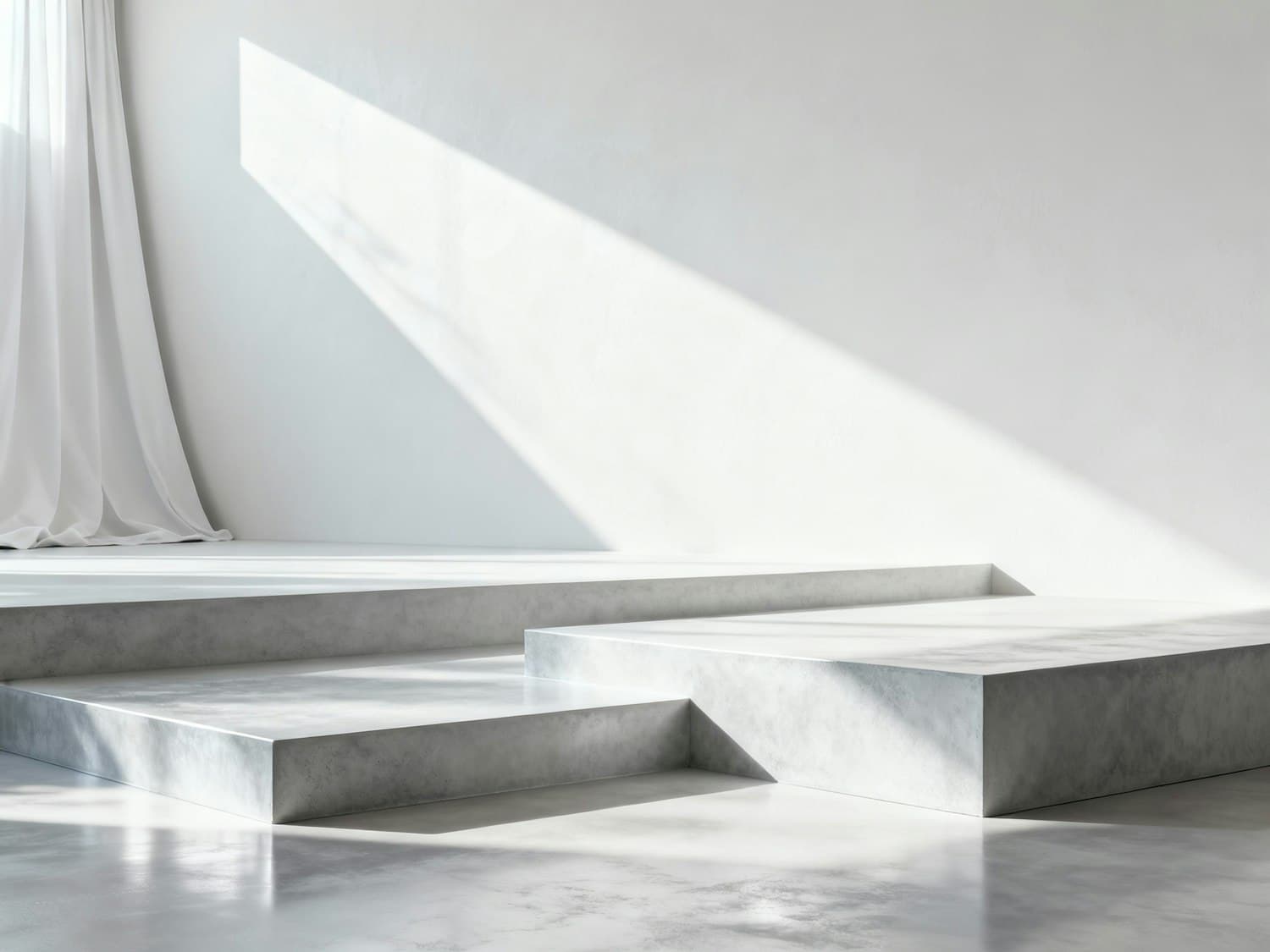Soft daylight falling across polished concrete platforms and a white curtain in a minimalist interior
